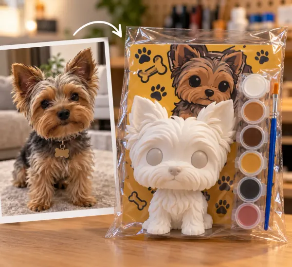 La foto de un perrito yorkie y, al lado, el kit con su figura impresa en 3D, lista para pintar.